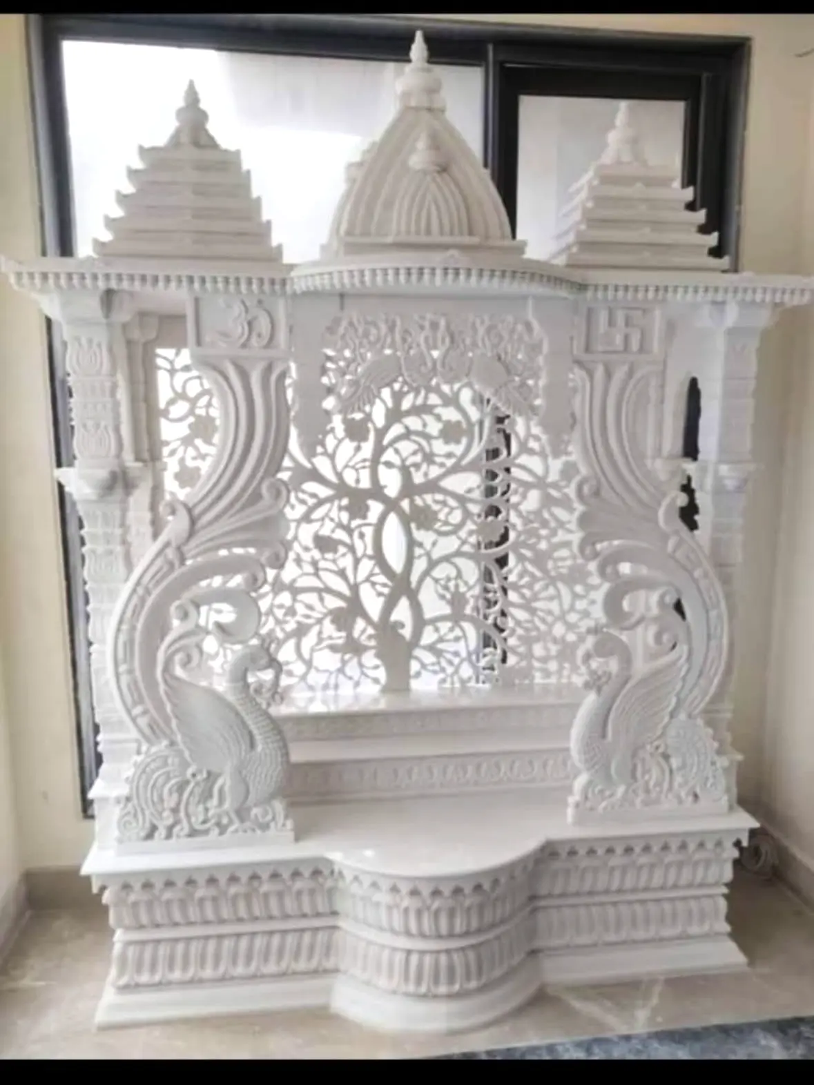 Beautiful marble mandir with intricate carvings and traditional architecture